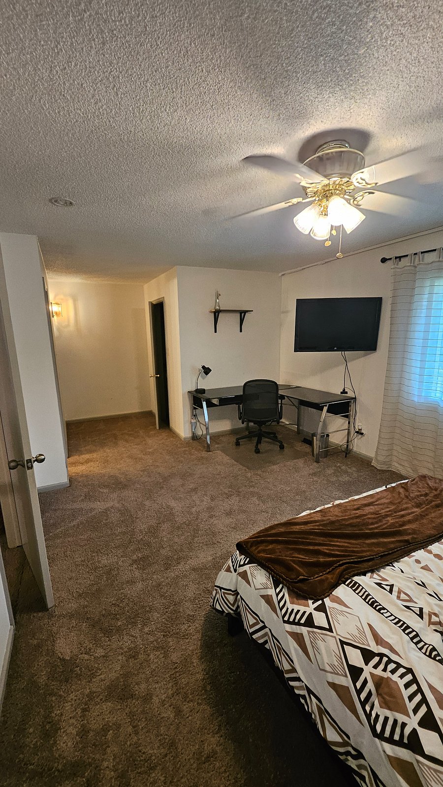 Extra large second bedroom with desk and TV.
