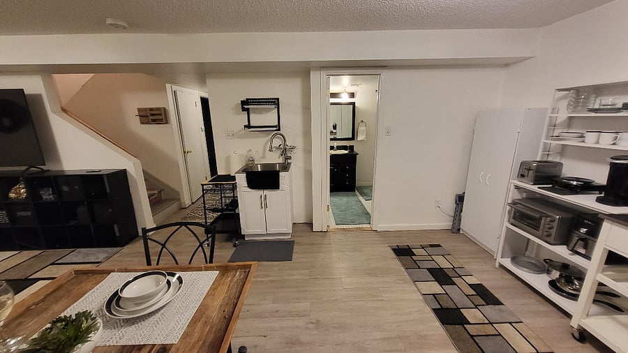 Basement living space (Current arrangement of furniture may vary).