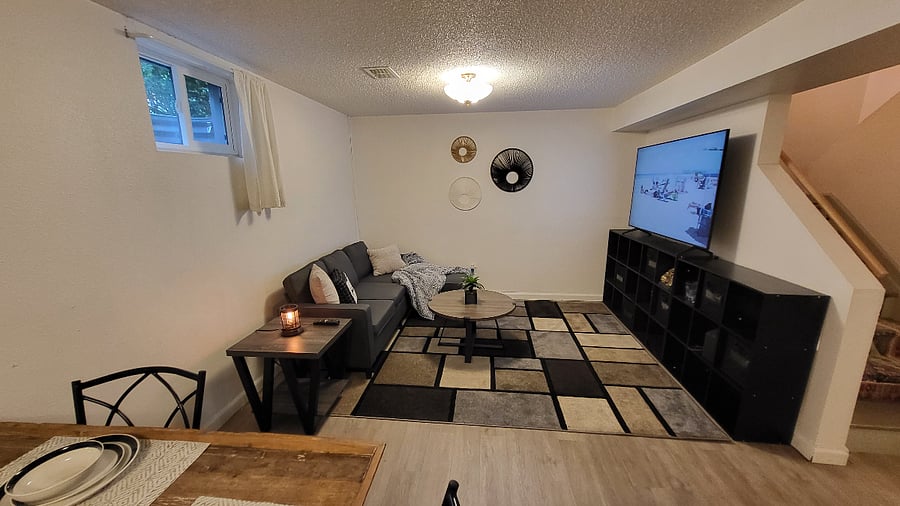 Basement living space (Current arrangement of furniture may vary).