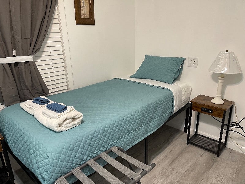 Bedroom number one with two twin XL beds smart TV, two luggage racks, two USB nightstands, and a large chest of drawers
