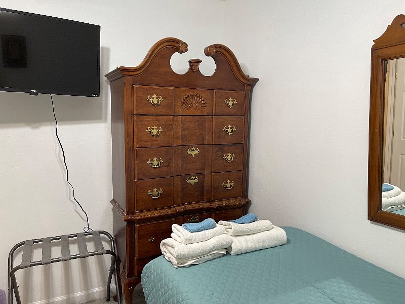 Bedroom number one with two twin XL beds smart TV, two luggage racks, two USB nightstands, and a large chest of drawers