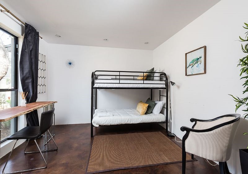 5th bedroom: Sleeps 3 people. Bunk bed is full size bottom and twin size top and is at the furthest end of the house so kids can sleep tight while the adults enjoy the rest of their Vacation Stay ! Also has its own 1/2 bathroom