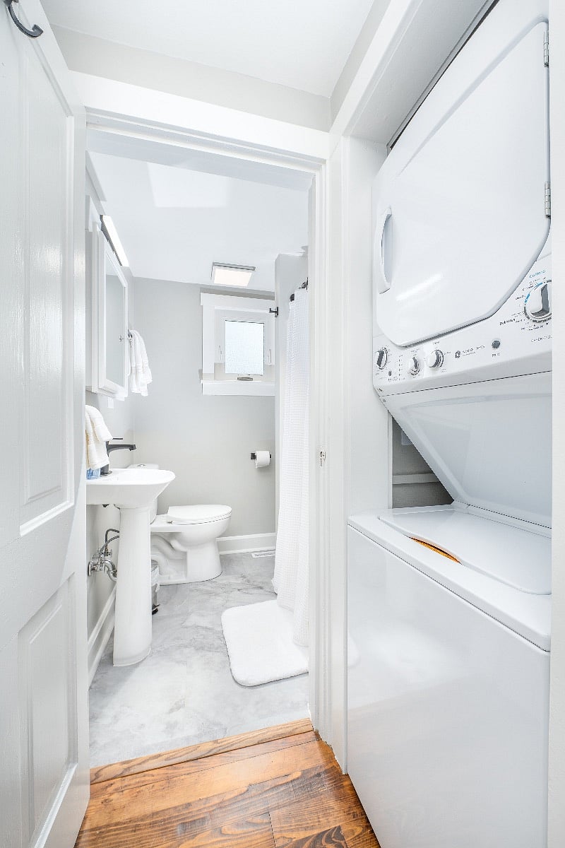 Stackable washer/dryer located right outside the bathroom.