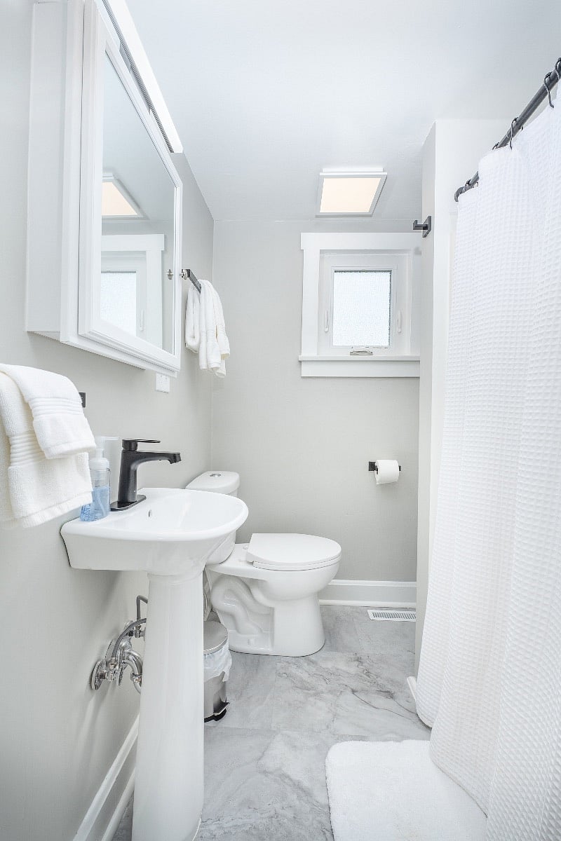 Pedestal sink and stall shower.