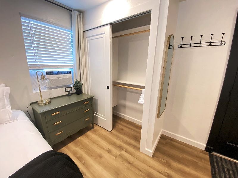 Ample storage space is available including a dresser, closet with double and single hanging, coat hooks, and under bed storage bins.