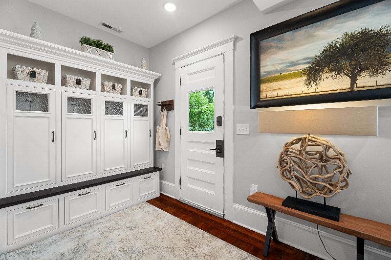Stay organized in our shared mudroom, featuring built-in lockers, bench seating, and convenient entryway decor.