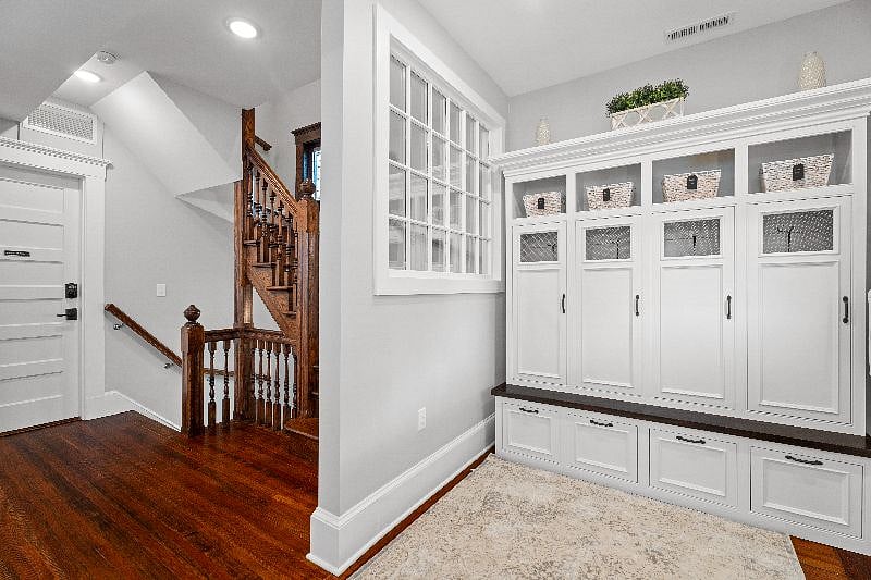 Stay organized in our shared mudroom, featuring built-in lockers and bench seating for your convenience.