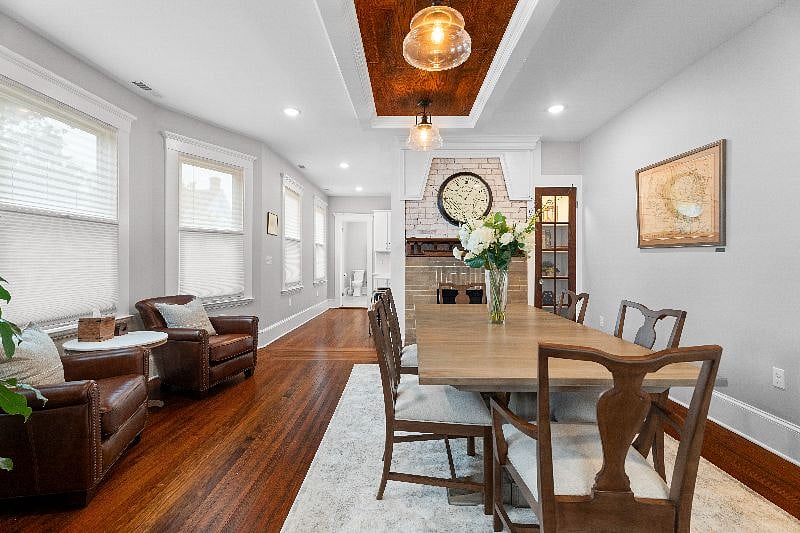 Enjoy meals in this elegant dining room, which features a classic fireplace, a large table with seating for six, and easy access to the adjacent kitchen.