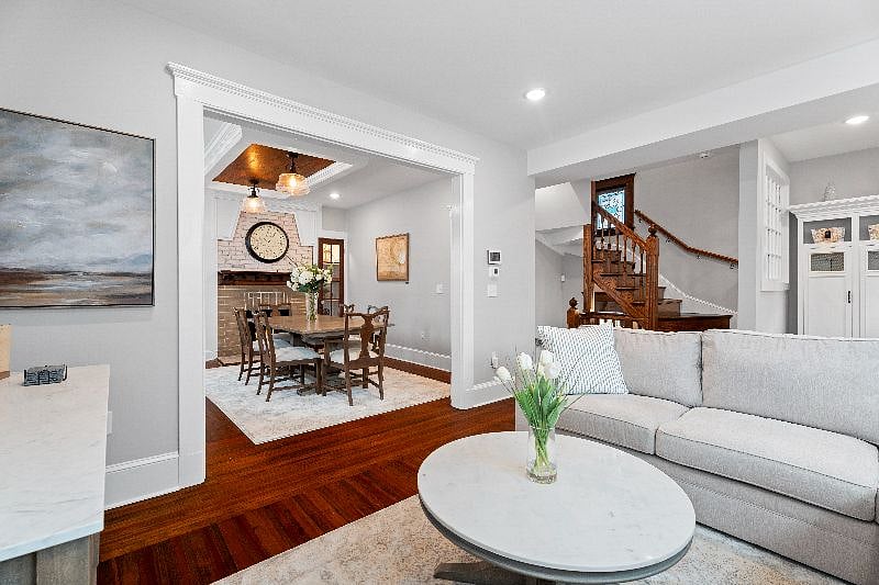Relax in our inviting living area, which flows seamlessly into a formal dining room featuring a classic fireplace and table seating for six.