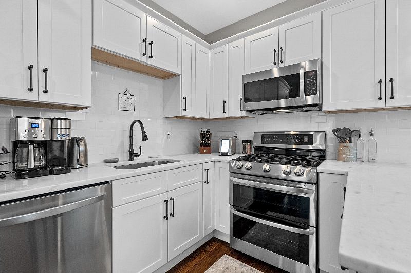 Prepare your favorite meals in this fully equipped, modern kitchen featuring stainless steel appliances and ample cabinetry.
