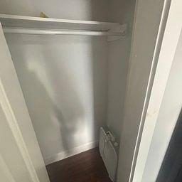 Closet featuring built-in shelving and a hanging rod.