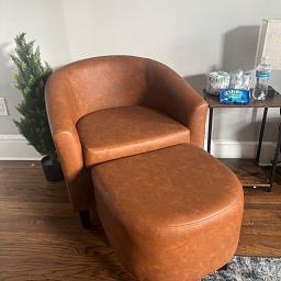 Cozy lounge chair with a matching ottoman.