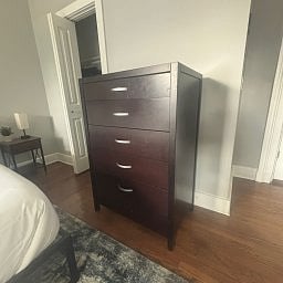 Tall dresser featuring five drawers.