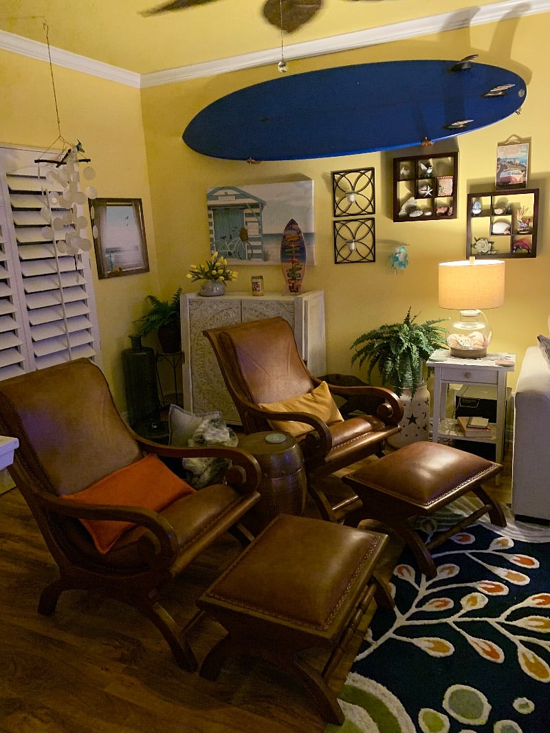 These chairs sit in front of the door out to the balcony. To the north is the game cabinet and to the south is the marble fireplace.