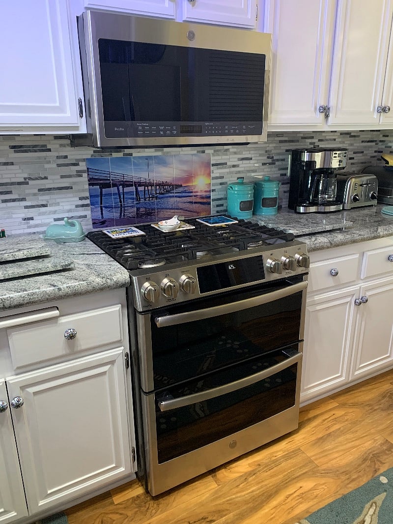 Double ovens, and five burner stove top. 