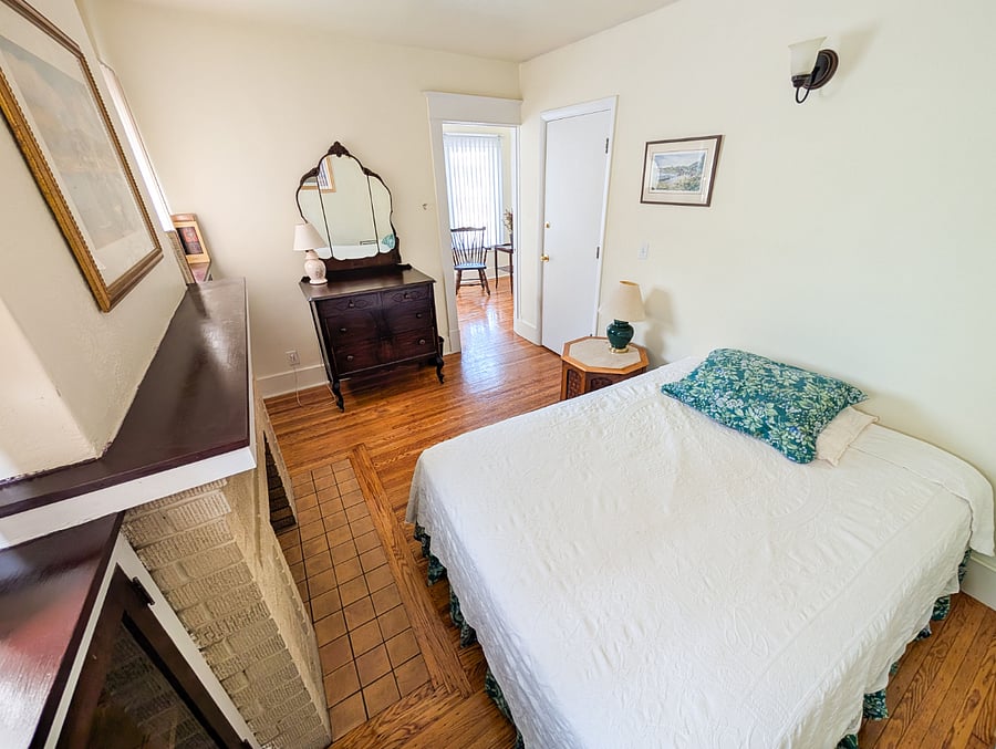 Bedroom #3
Cozy full bedroom featuring a charming decorative fireplace.