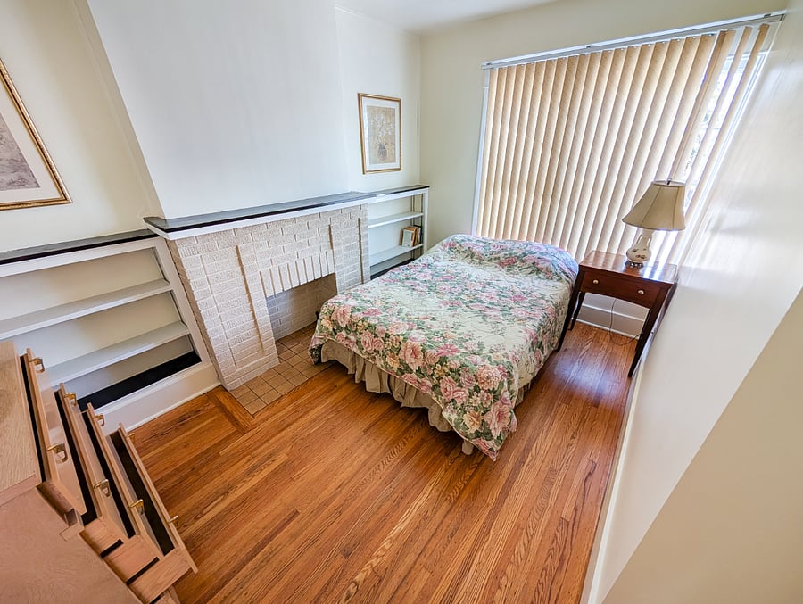 Bedroom #3
Cozy full bedroom featuring a charming decorative fireplace.