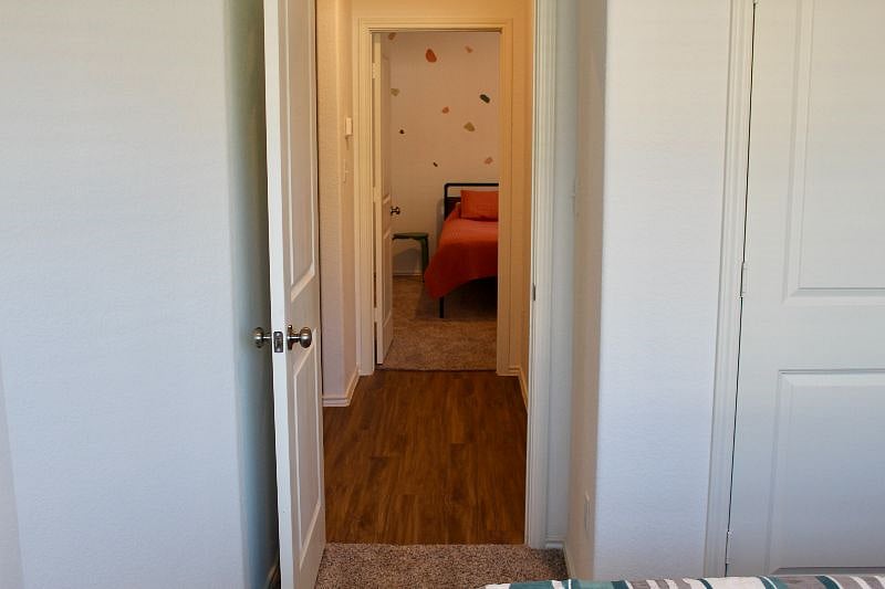 View of the second bedroom from the front bedroom. The guest bathroom is located between them on the right. The entry hall is between them on the left.