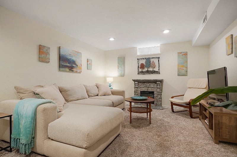 Living room features dimmable ceiling lights, reading lamp, electric fireplace, and smart TV with free streaming apps.