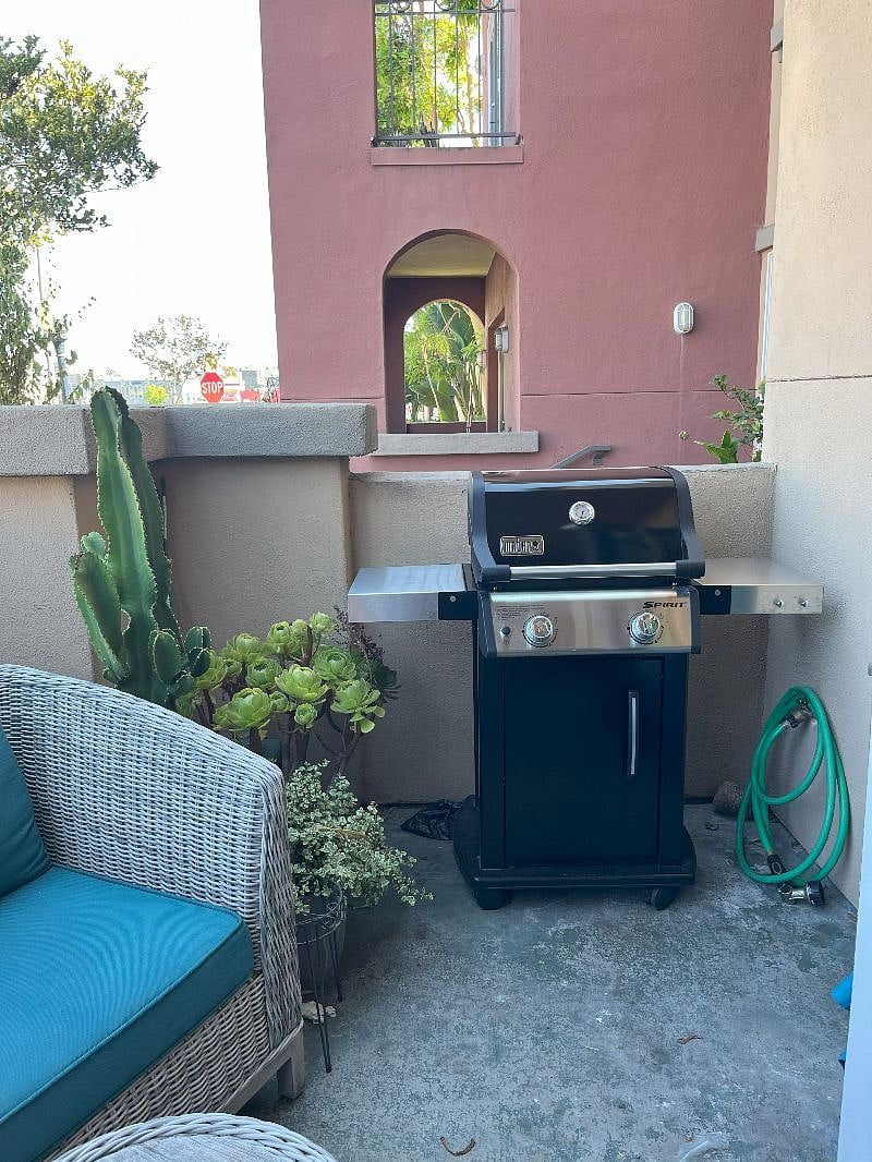 Propane grill on a sweet front patio.
