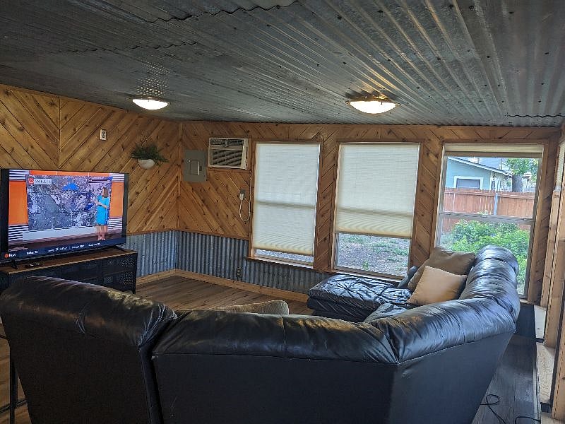 Den - back of leather couch sectional, 65" smart TV