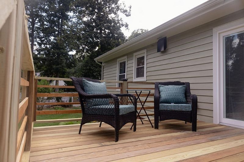 these wicker chairs were replaced with comfortable steel chairs and an umbrella has been added