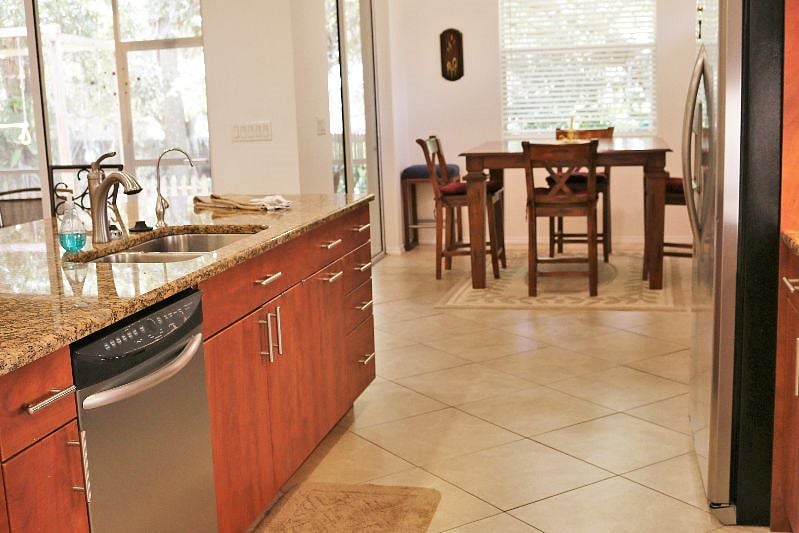 Full kitchen, dishwasher, open to pub style dining area. Bar stools at bar offer 3 additional seats. Built in desk next to fridge for workstation.