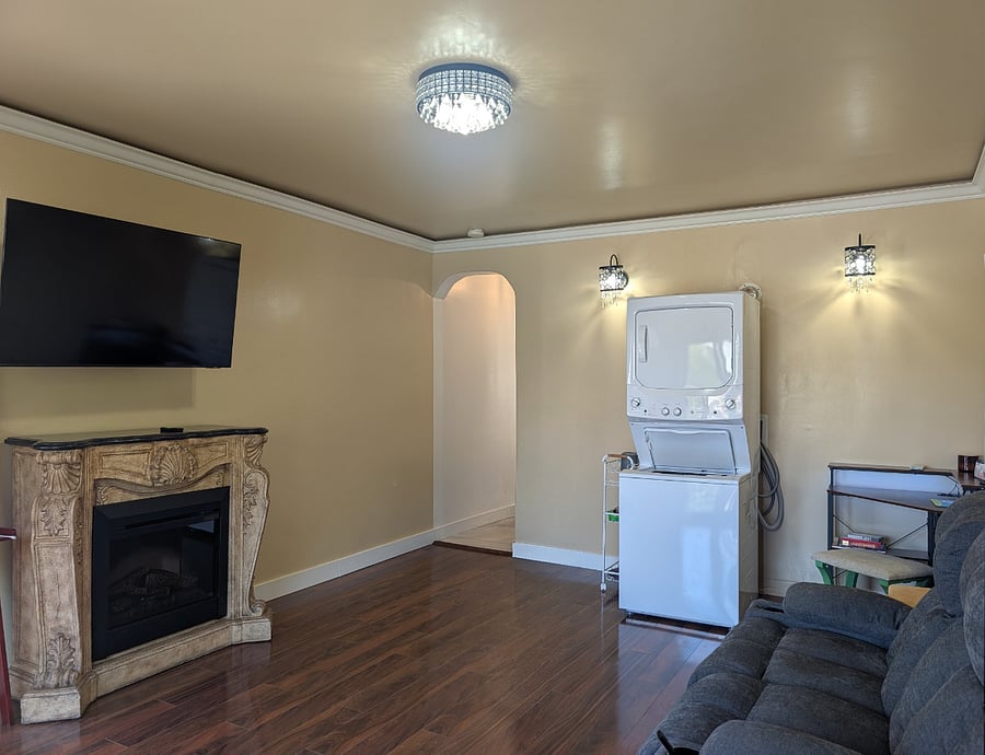 Living Room has a Smart TV and electric fireplace with natural light from the private balcony.