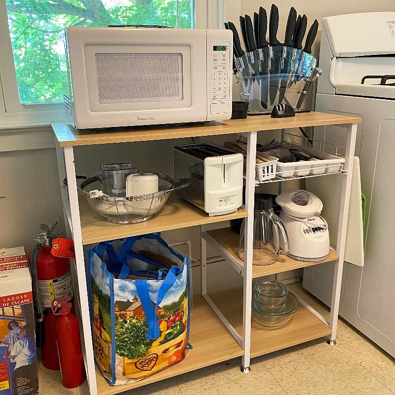 Kitchen shelf for microwave, silverware, and other essentials. This faces West and looks out to the big tree.