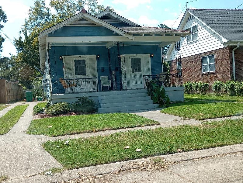 Cozy, deep, shaded front porch with Swing and Rockers