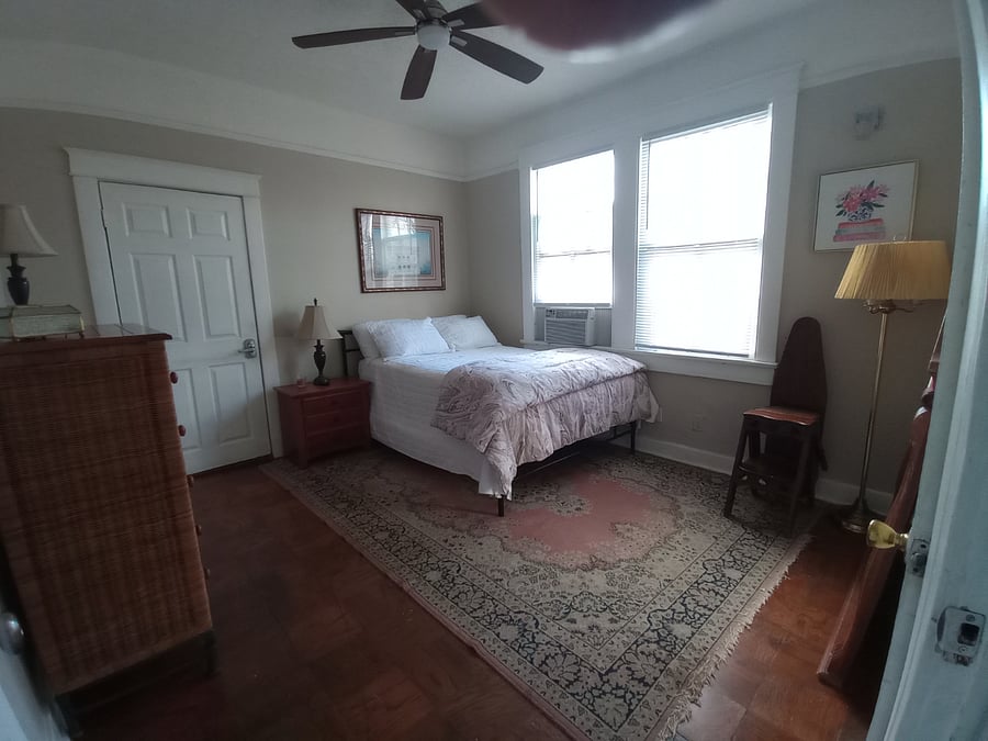 Bedroom 2, with Full Iron Bed, chest of drawers and dressing mirror.