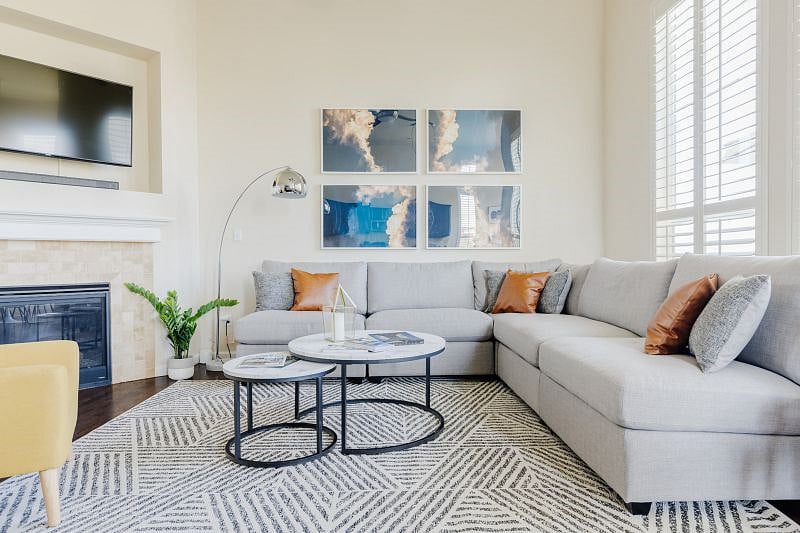 Spread out this spacious and professionally designed and decorated living room. Switch on the indoor gas fireplace, log into your favorite streaming account on the smart tv and get the tunes going with the the bluetooth sound bar. The large sectional couch doubles as an extra sleeping space. Huge room with tons of light, tall ceilings, fan w/ remote, and wood shutters.
