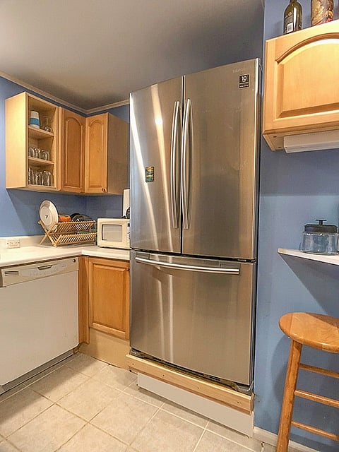 Full size double door refrigerator with large, pull out freezer drawer.