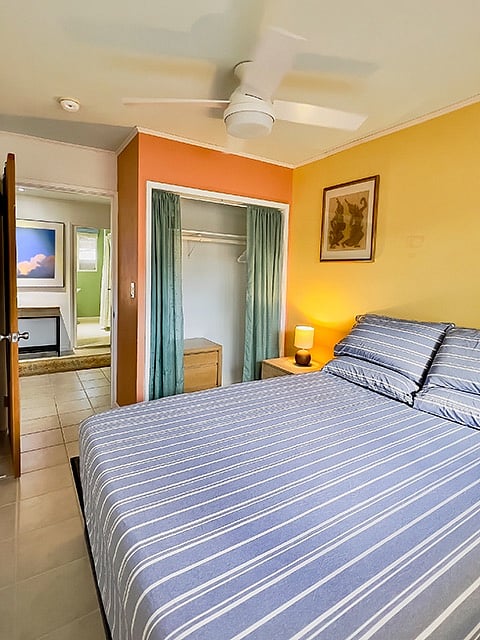 the Bedroom features a five foot closet and a new queen bamboo memory foam mattress on a raised pedestal. The large opening window on the opposite wall faces the Tradewinds and has slat blinds and blackout curtains for daytime sleeping.