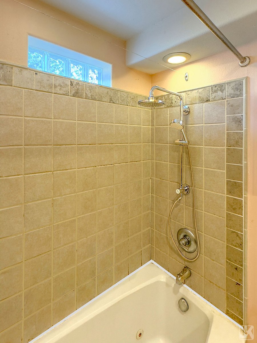 a Grohe rain shower and jacuzzi tub provide options in the bathroom.