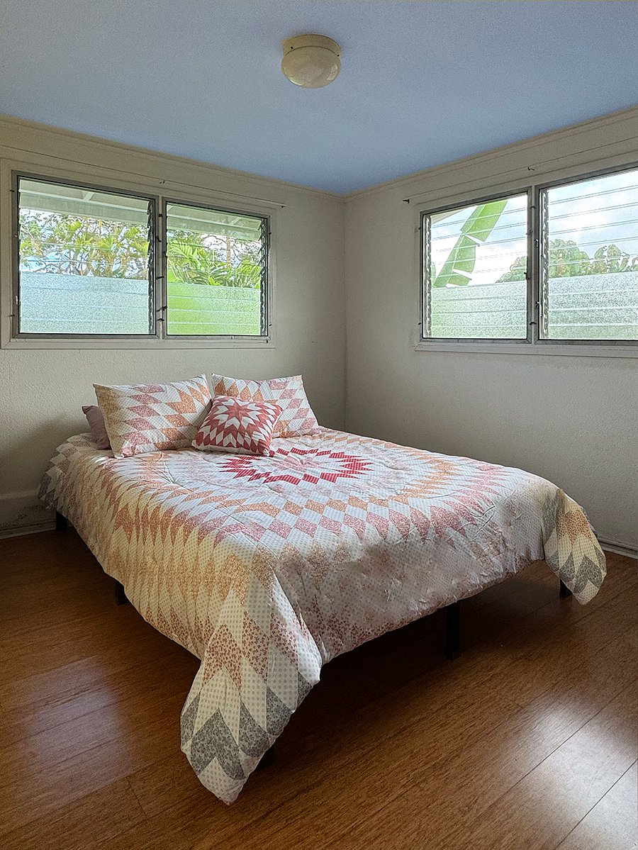 You can count on restful sleep in this queen bed in a quiet, airy bedroom.