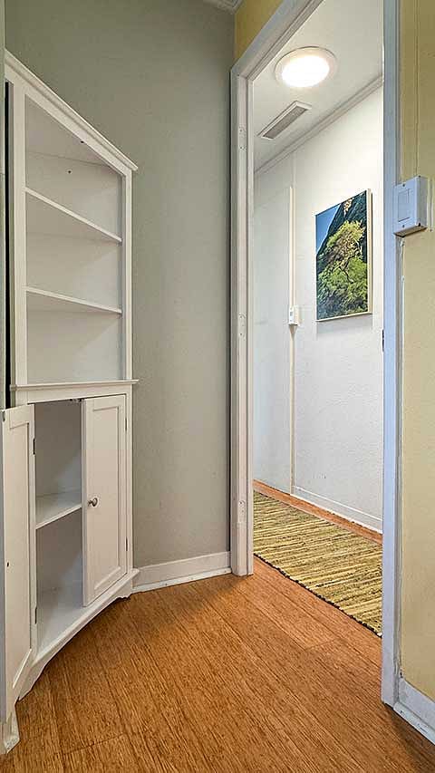 Bamboo floors and a tailored color scheme grace the doorway from living room to hallway.