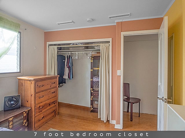 Seven feet of closet including a cordless stick vacuum make clothes storage and cleaning easily organized.