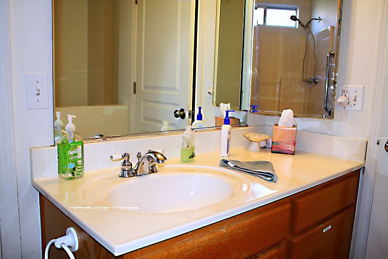 Hair dryer and first aid kit under the sink.