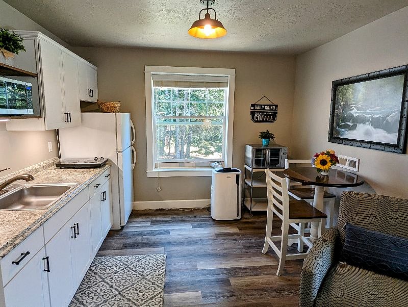 Fully stocked kitchen with countertop cooktop and convection oven.