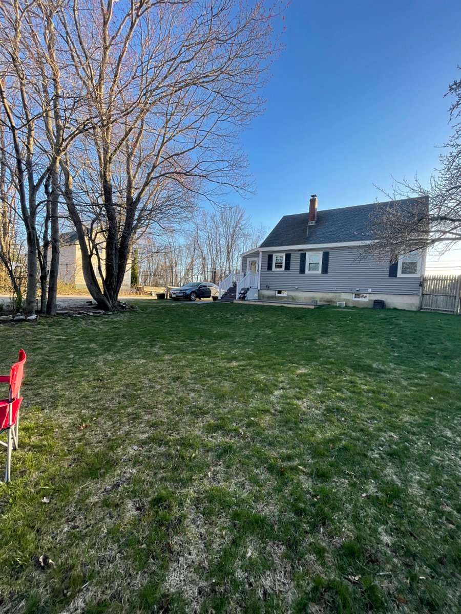 Yard looking at back of the house where main entrance is located 