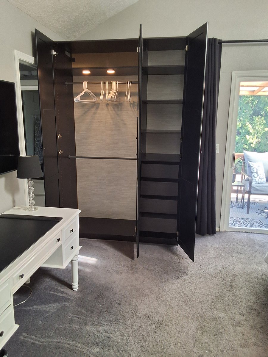 Primary bedroom with large wardrobe open