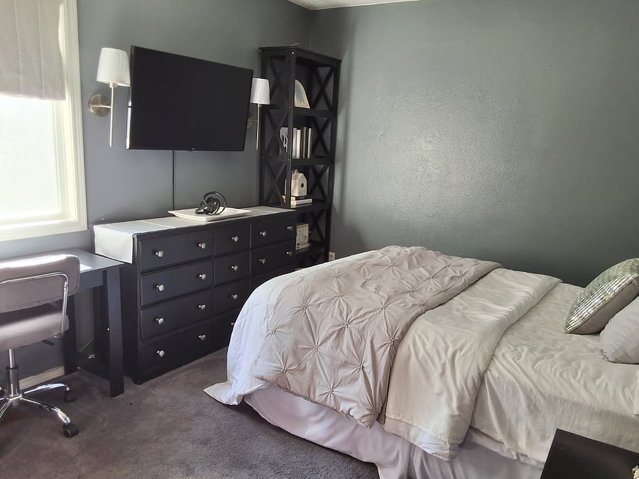 Third bedroom, desk, dresser, smart tv, bookshelf