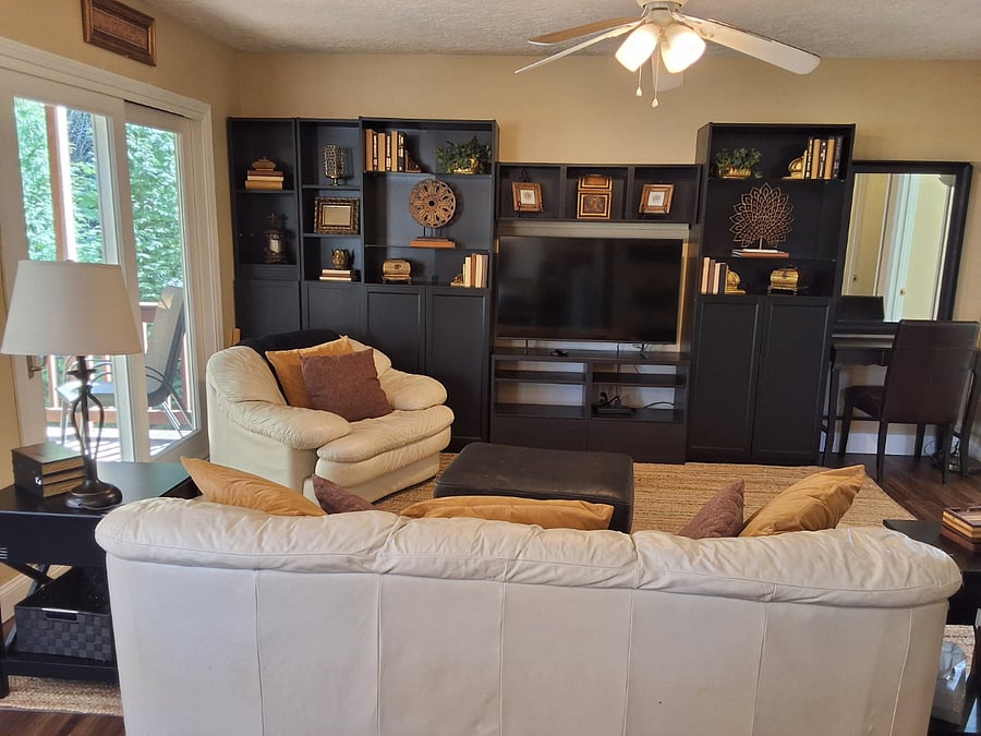 Family rm with leather seating and built-in entertainment center and Roku enabled tv