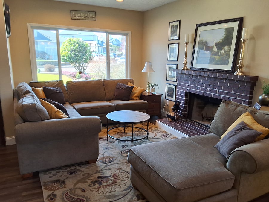 living room with working fireplace and sectional seating