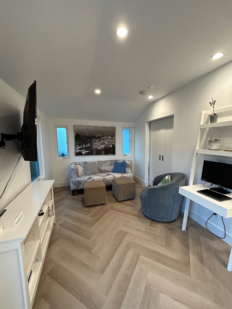 Ample seating area with sofa and plush chair along with a desk with Monitor and Keyboard to hook your laptop up to!