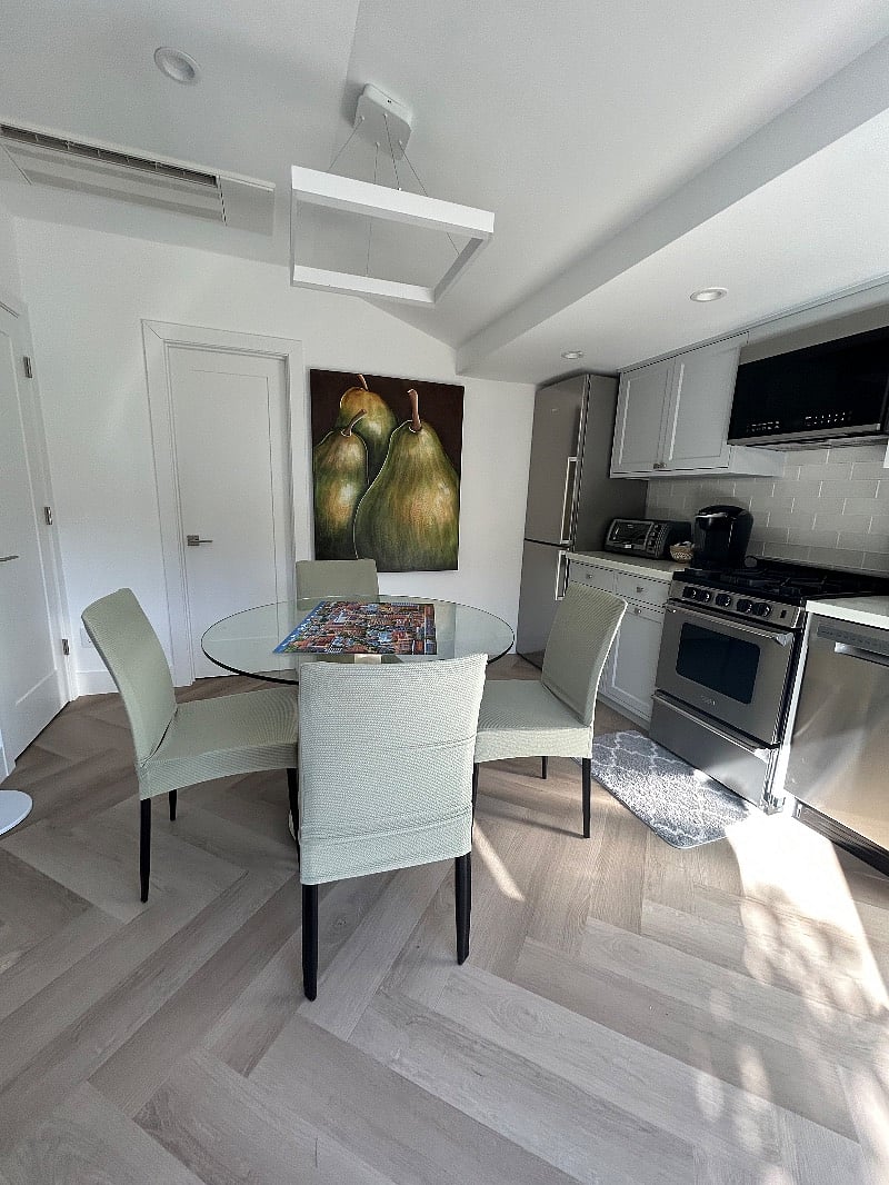 Dining area for four with light from French Doors. Door in rear is to bathroom.