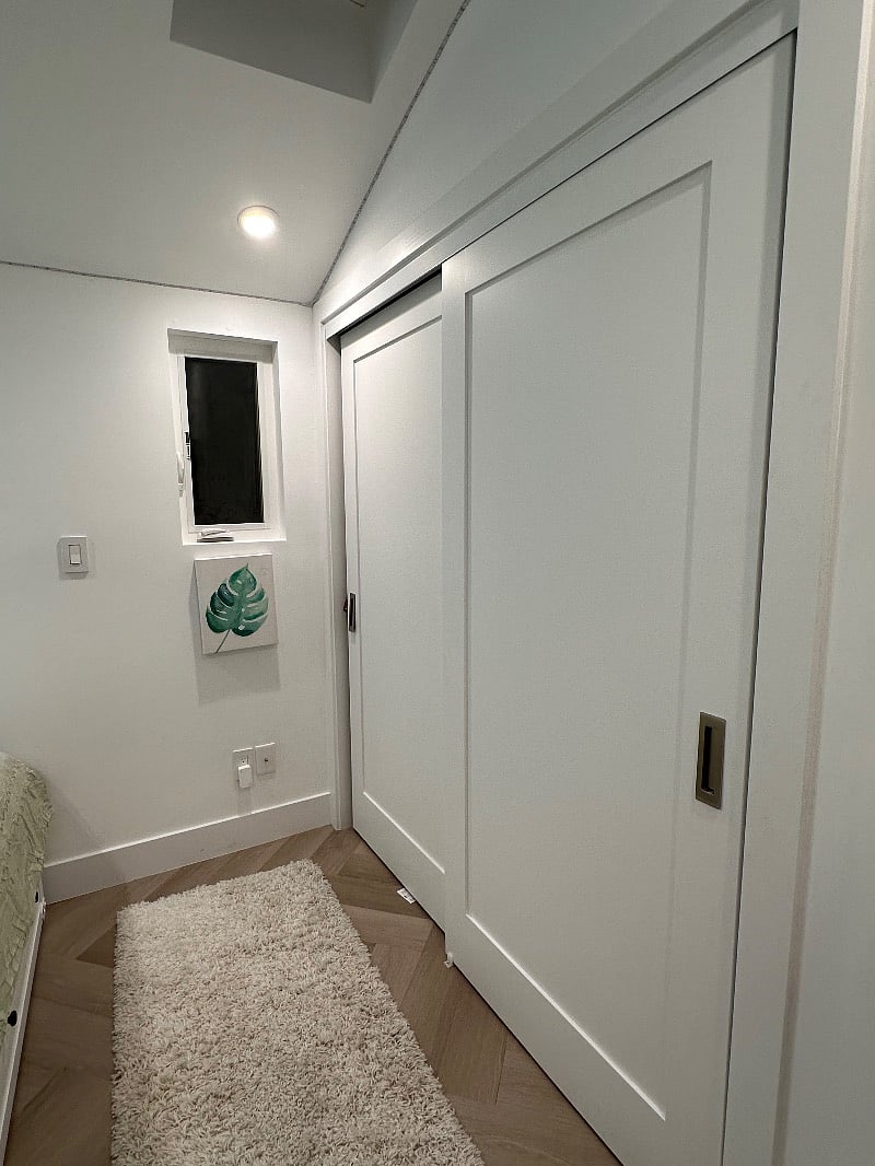 Bedroom has double expansive hanging closet and two large dresser drawers under bed.