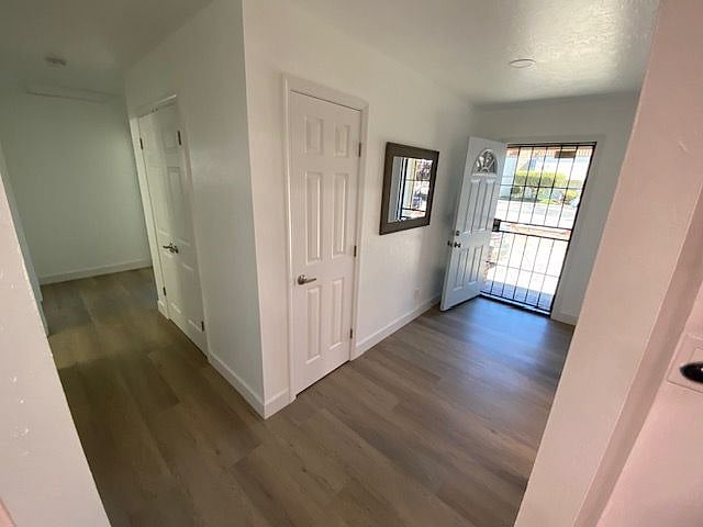 Front door entrance and hallway to back bedrooms (from kitchen entry)