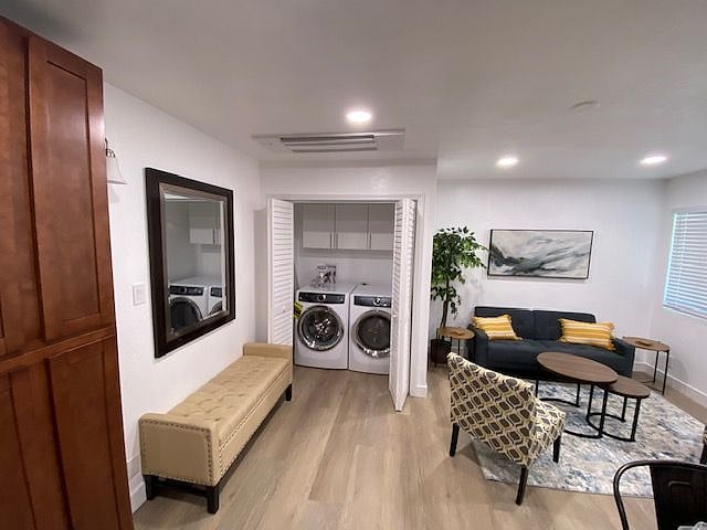 Food pantry on left; family room view includes washer and dryer behind shutter doors